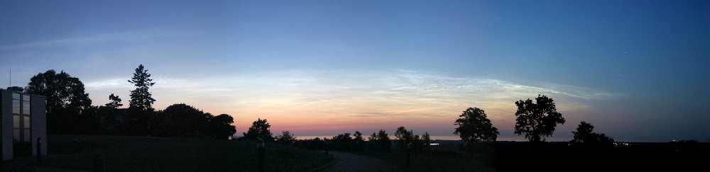 Fig. 1:Noctilucent cloud display seen from Kühlungsborn, Germany, on June 24, 2005 while the sun is about 8 degrees below the horizon. (courtesy, G. Baumgarten)
